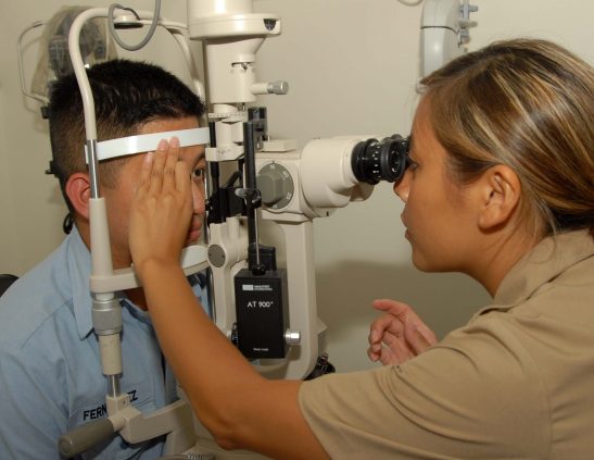 Navy optometrist Lt. Thuong Le administers a slit lamp eye exam to Serviceman Seaman Alfernan Fernandez at Branch Medical Clinic Naval Base San Diego. (U.S. Navy photo by Mass Communication Specialist 3rd Class Rialyn Rodrigo/Released)